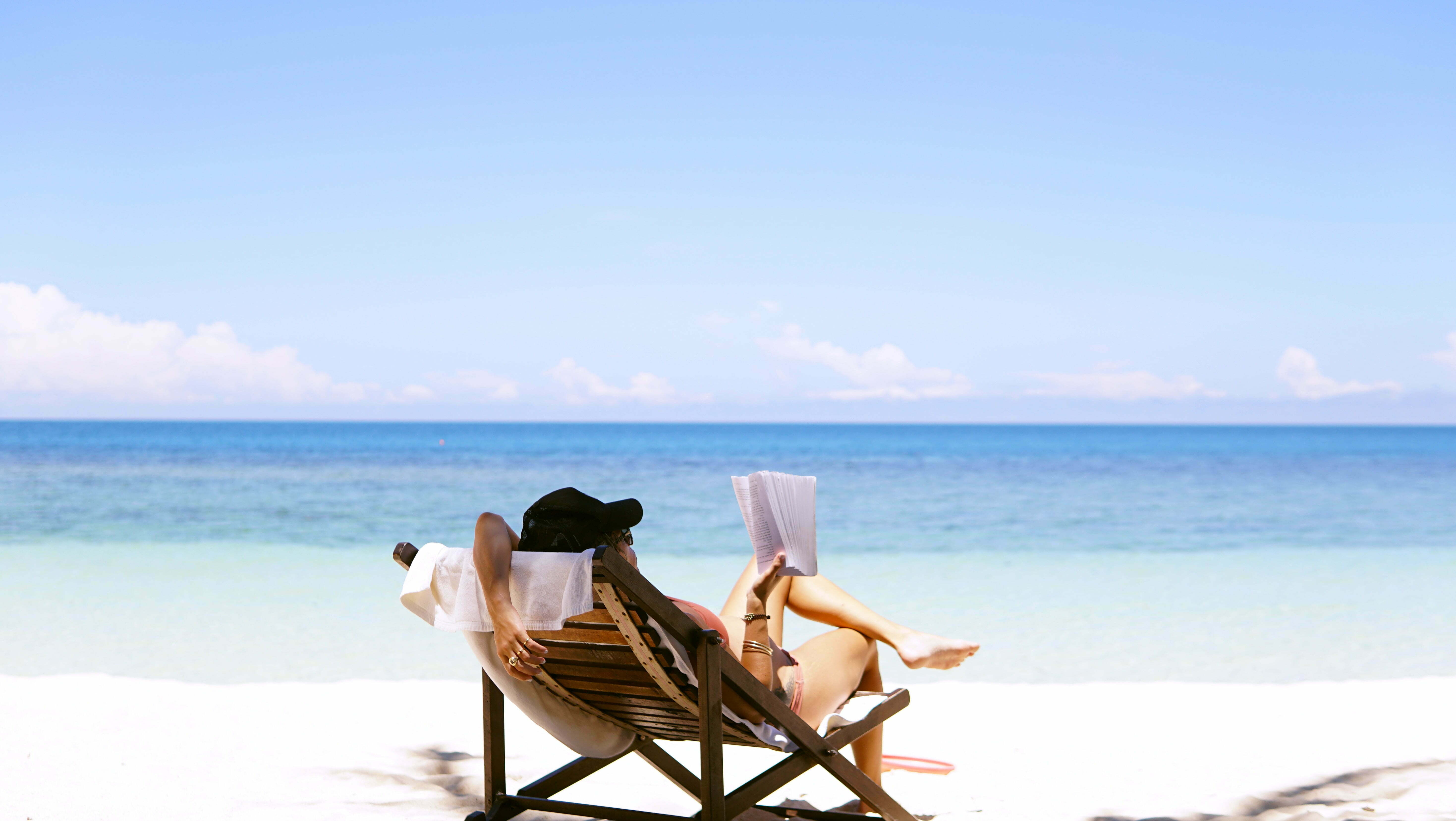 a group of people relaxing on chairs on a beach