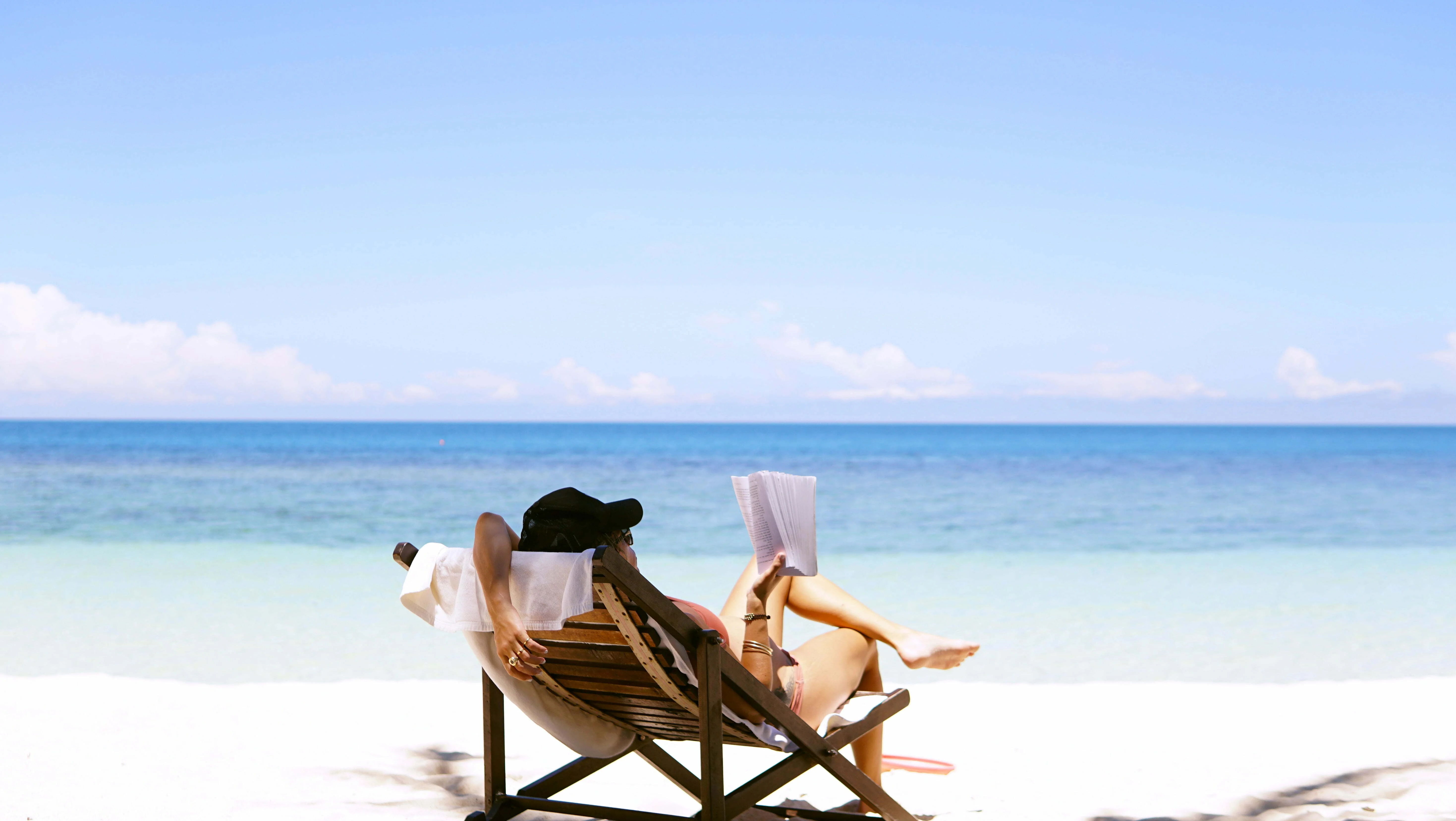 a group of people relaxing on chairs on a beach