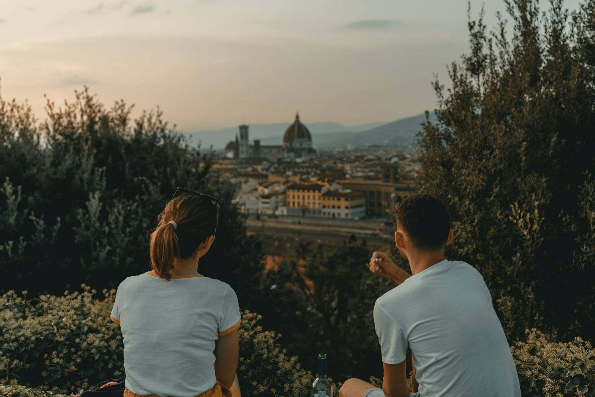 a man and woman looking at a city
