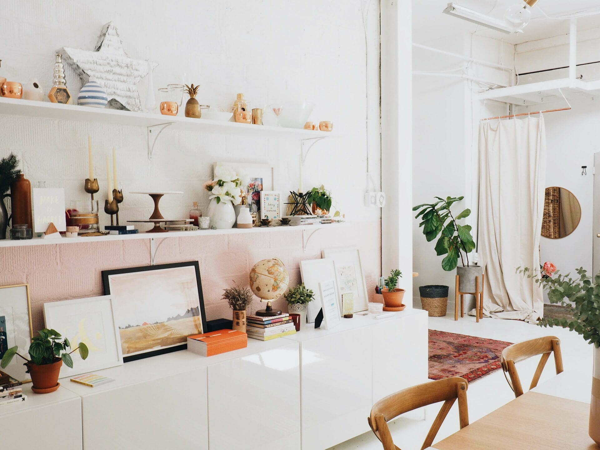 a white kitchen with a large screen