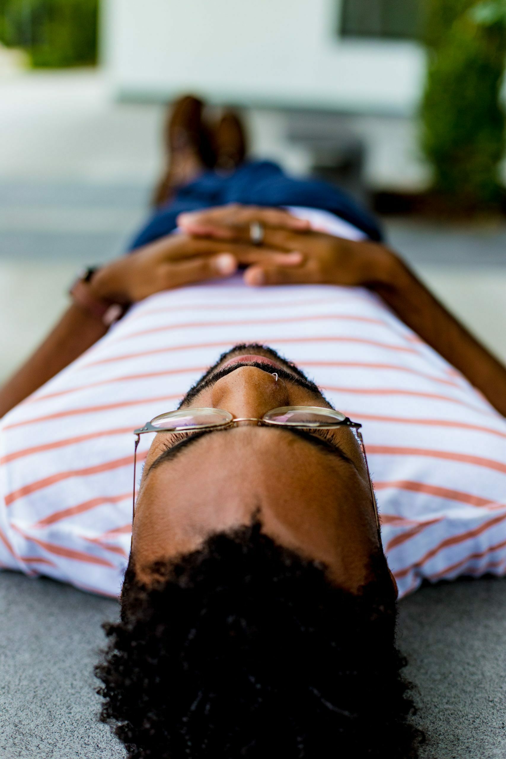 a person lying on a striped pillow