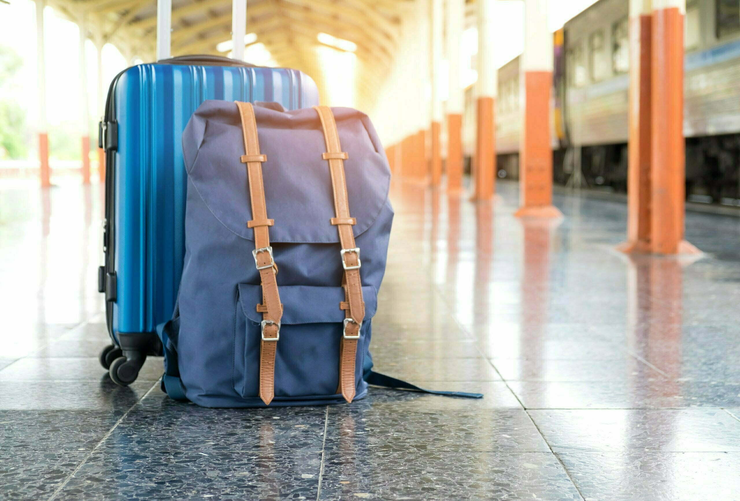 a blue suitcase on a tile floor